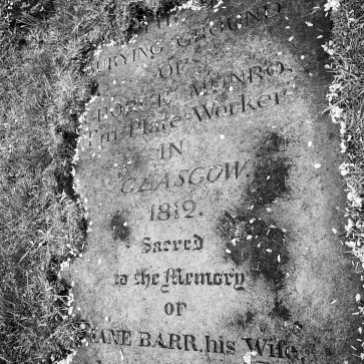 Gravestone of a tinsmith buried in the ground